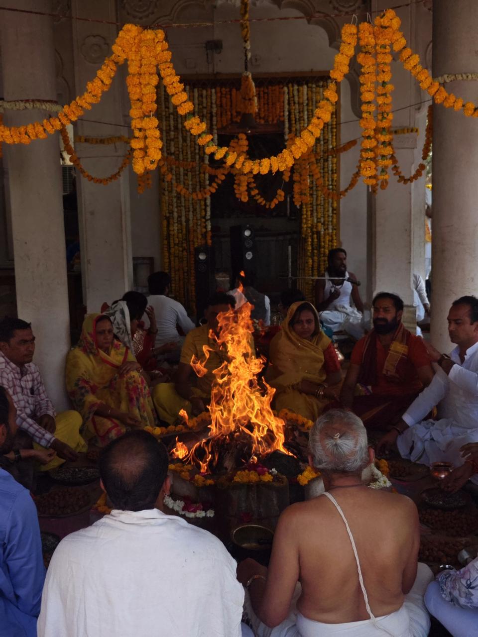 Devotees gathered around the sacred havan