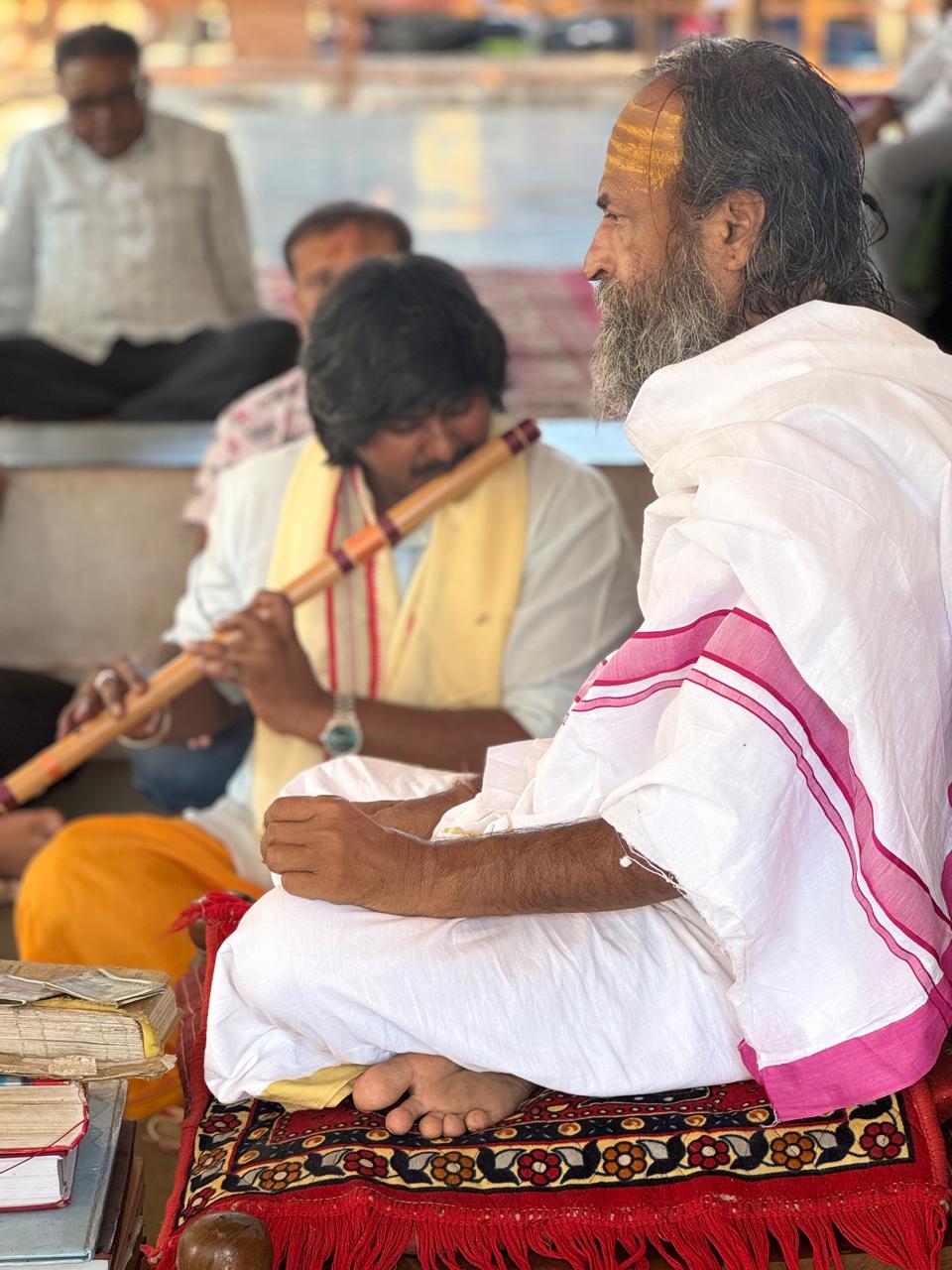 Devotees offering puja with the Acharya
